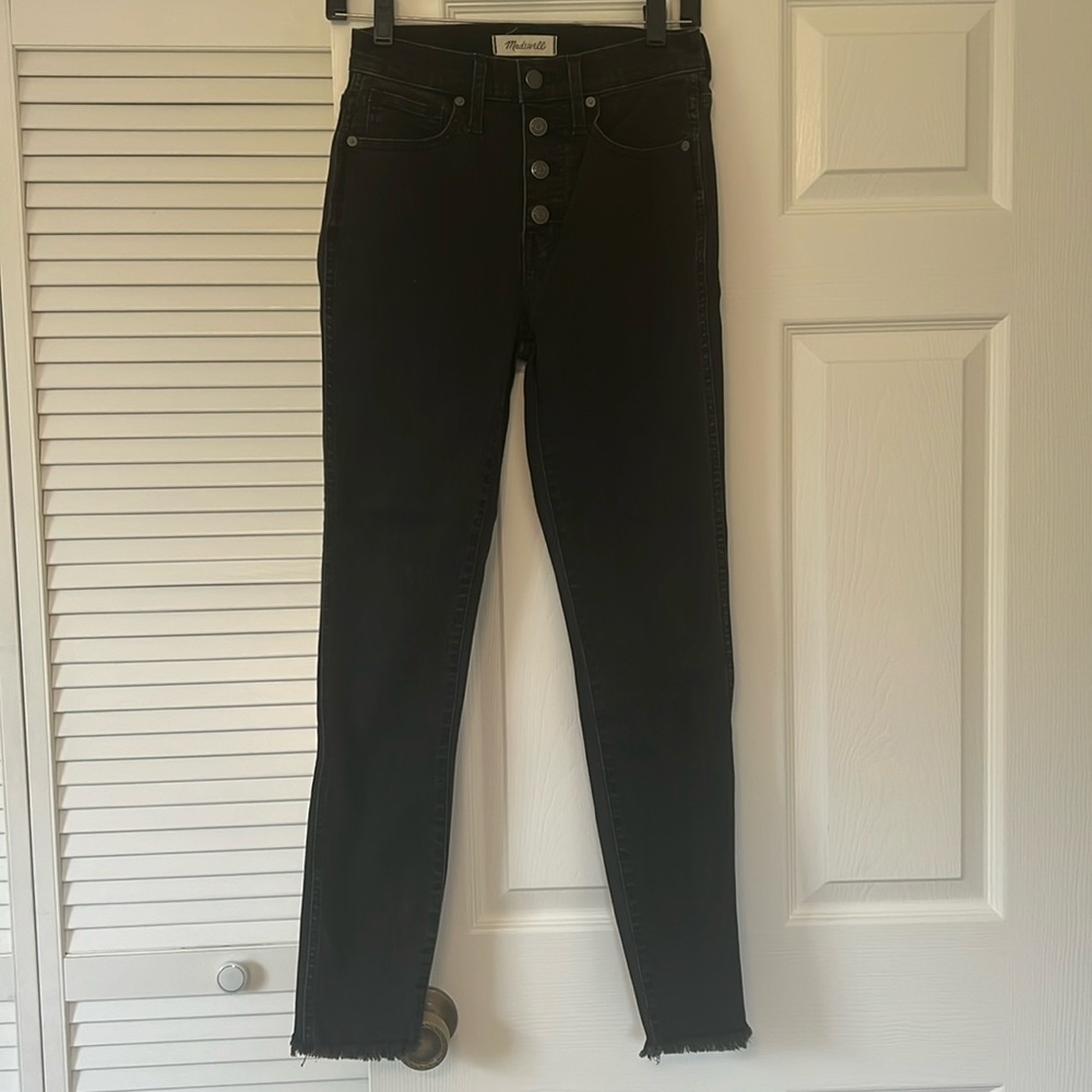 Madewell skinny black jeans. Size 25. Raw hem exposed buttons